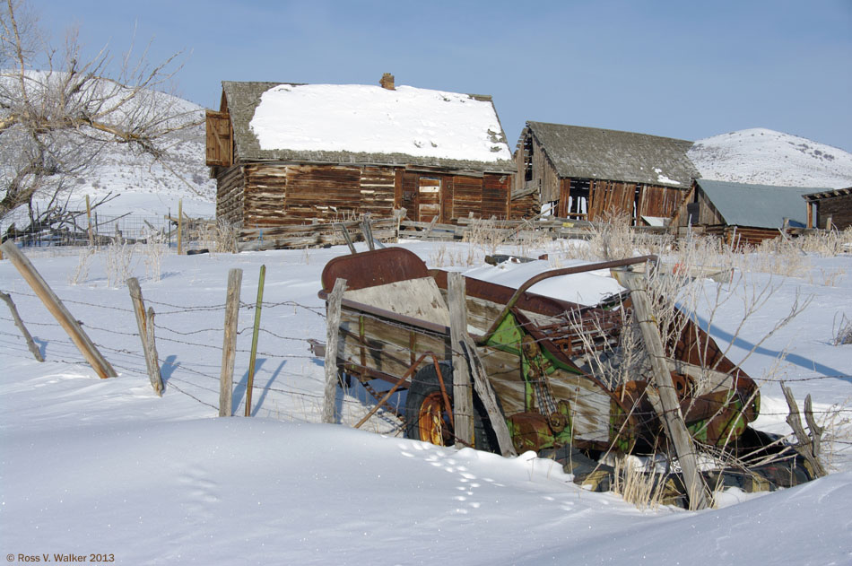 Log cabin and manure spreader, Bern, Idaho